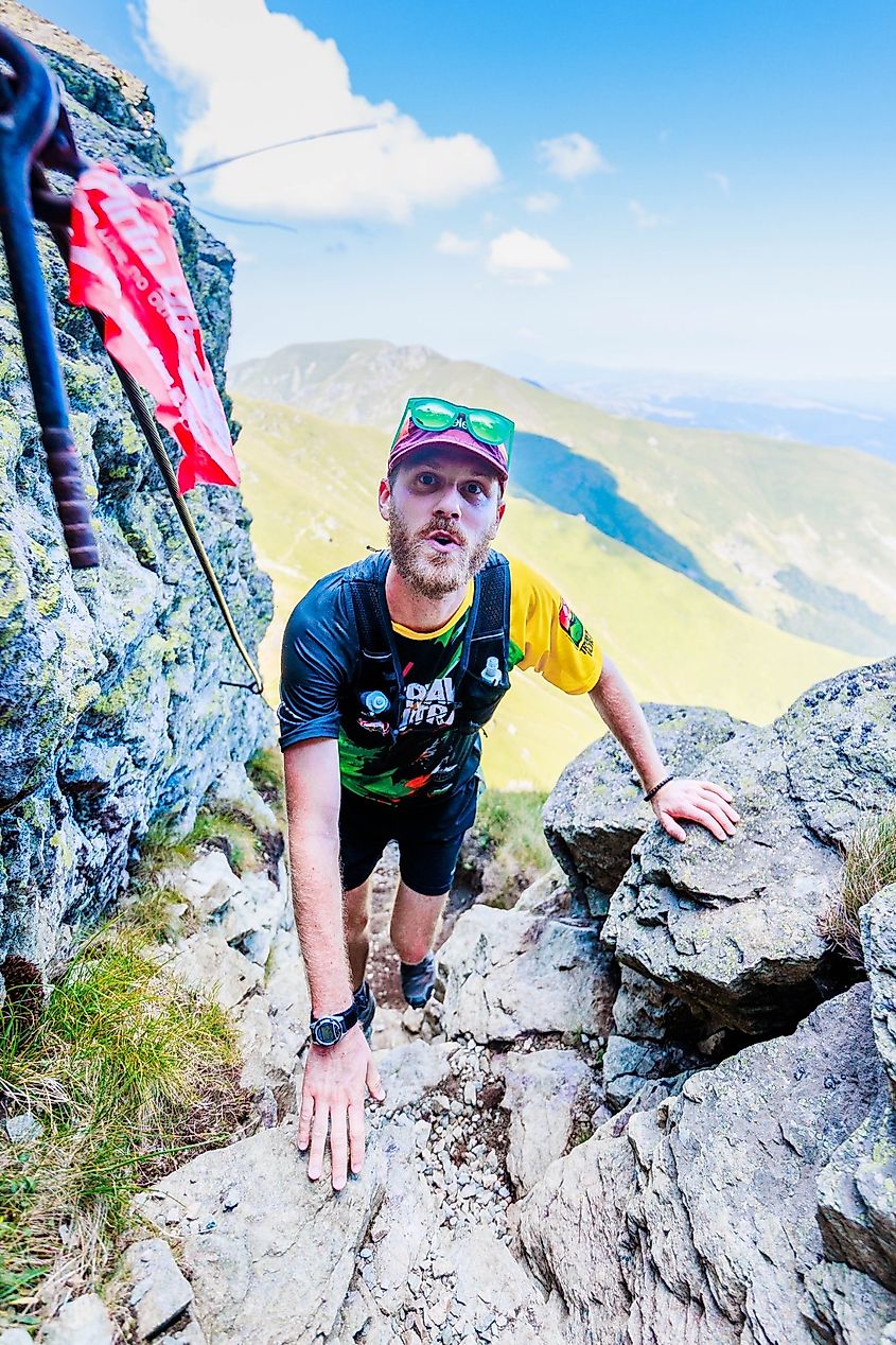 Author, Andrew Douglas, coming up through a crack in the mountains in the Balkaniada Sky Race