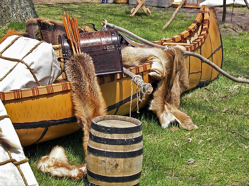 fur pelts and trunk in Indian canoe