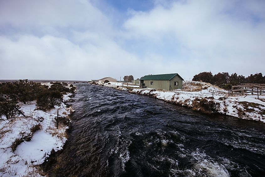 The landscape and canal in the hamlet of Liawenee after a spring snow storm in the Central Highlands in Tasmania Australia.