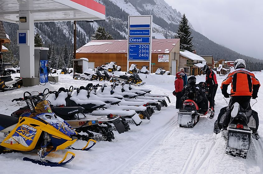 Snowmobiles in Cooke City Montana at a gas station