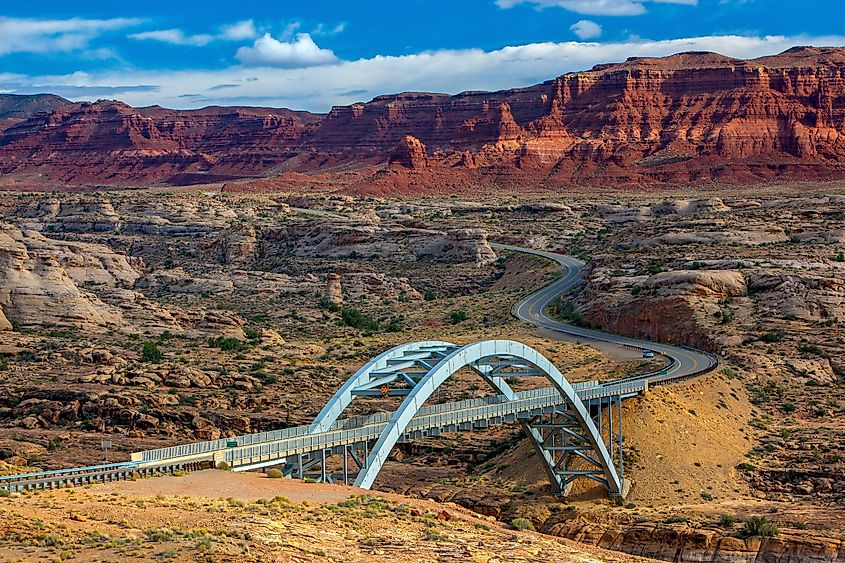 Long and scenic Bicentennial Highway (Utah State Route 95) through desert rock formations near Blanding, Utah