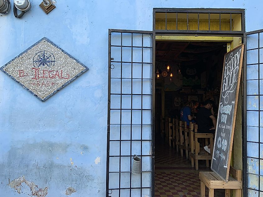 The blue exterior of a hole in the wall bar called El Ilegal