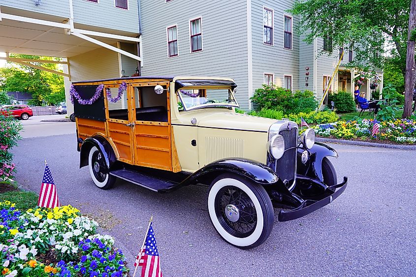 An antique car in front of Bar Harbor at Acadia National Park, Maine
