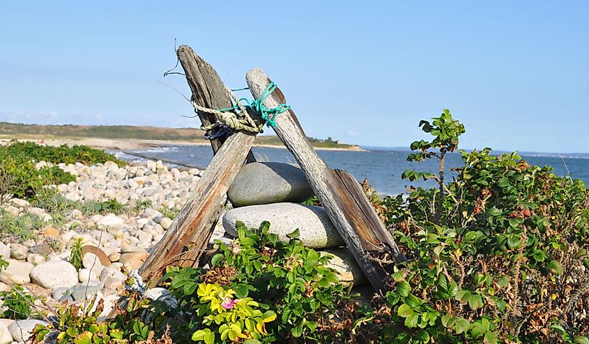 Cuttyhunk wooden beach sculpture with the ocean in the background