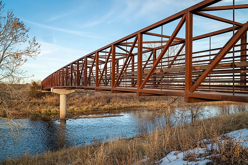 Bike trail and a footbridge over a river - South Platte River Trail near Brighton, Colorado.