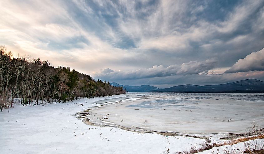 Ashokan Reservoir winter scene with dramatic sky, mountains, snow and ice.