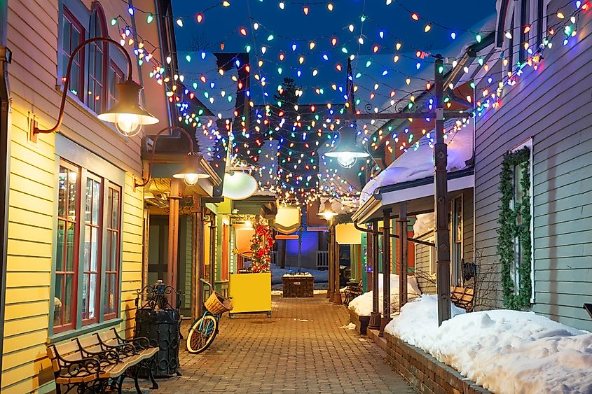 Breckenridge, Colorado, USA downtown streets at night in the winter with holiday lighting.