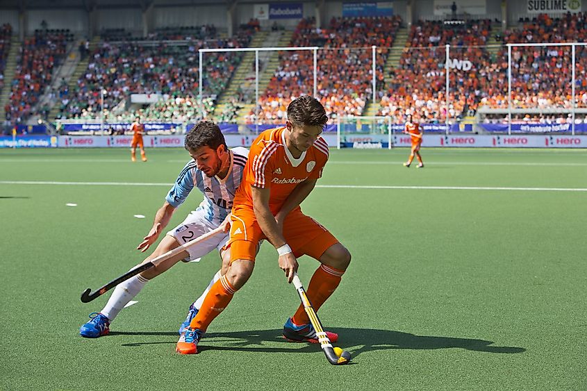 Hockey player Kemperman (NED) fencing off Brunet (ARG) during a charge at the Hockey World Cup