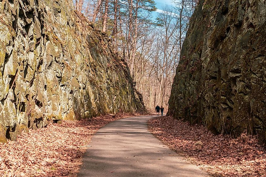 A couple walks on a path on the deep cut, a feature at blackhand gorge state nature preserve.