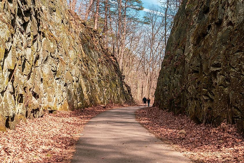 A couple walks on a path on the deep cut, a feature at blackhand gorge state nature preserve.