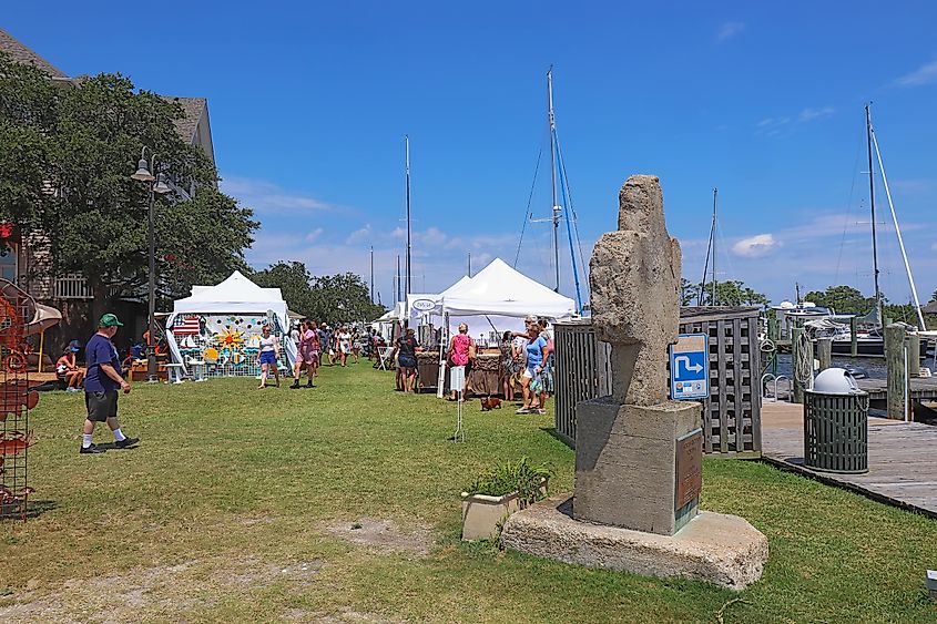 Vendors and shoppers at the 38th Annual New World Festival of the Arts, a juried outdoor festival for fine art and crafts on the Manteo Waterfront every August, via Stephen B. Goodwin / Shutterstock.com