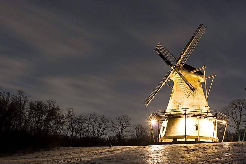 Color photograph of a windmill in Geneva Illinois during a winter's night.