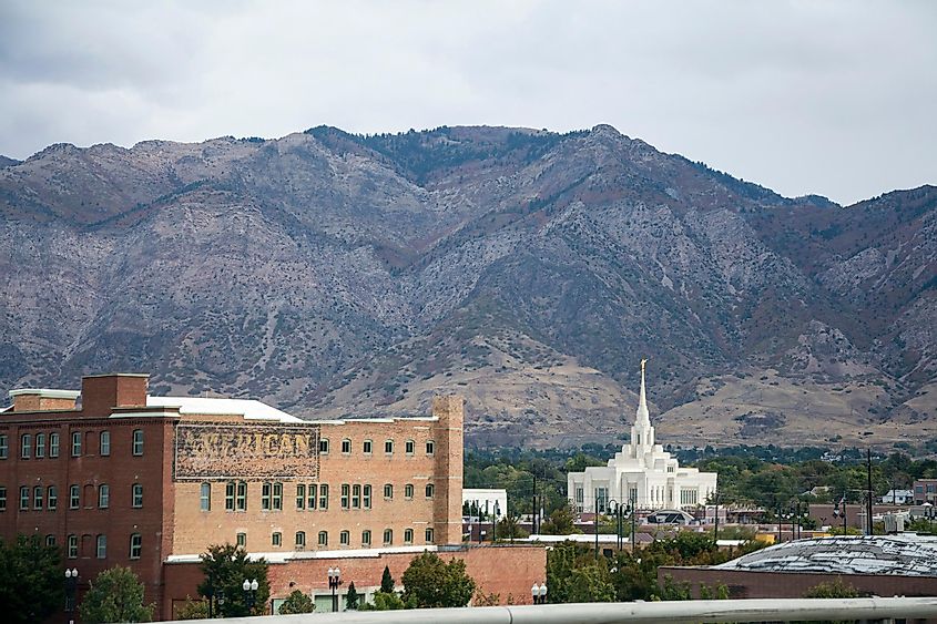 Mormon temple and old buildings with mountain backdrop in Ogden