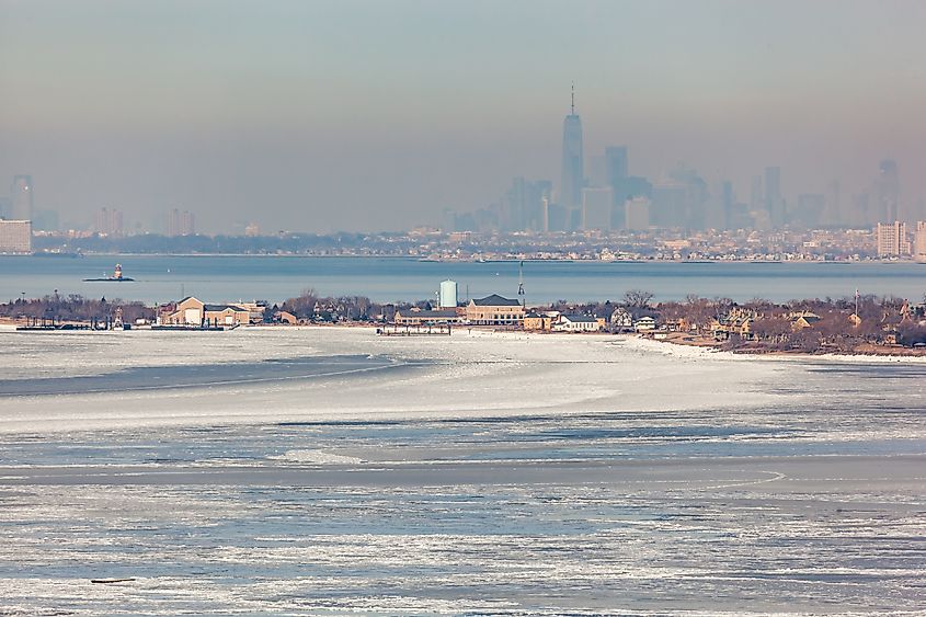 A view from the Atlantic Highlands across the frozen Sandy Hook Bay to Sandy Hook and New York City on a winter day.