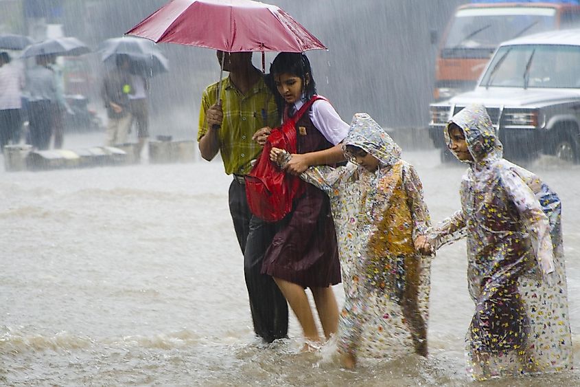 Children going to school in the heavy rains during the monsoon season in India. 
