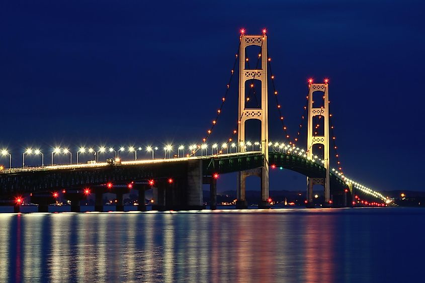 The well lit up Mackinac Bridge at night.