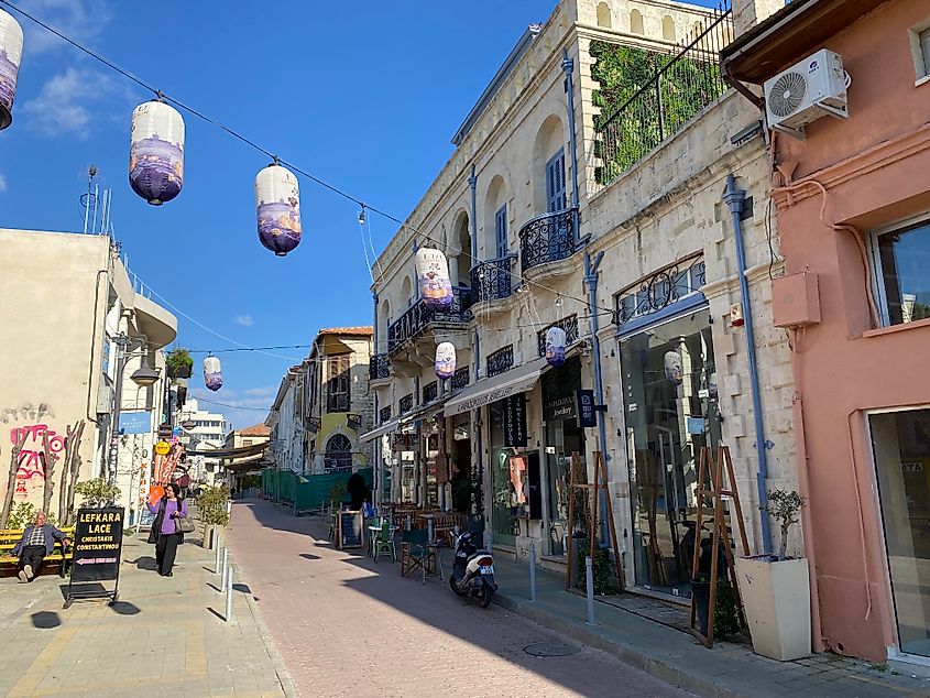 One off pedestrians walking through a colorful, if edgy, Old Town in Limassol, Cyprus.