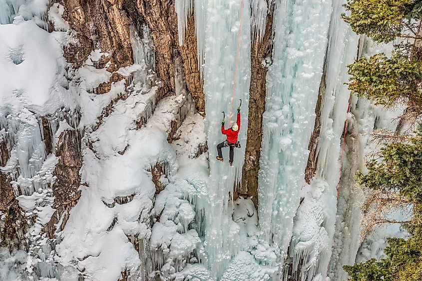 Ice climber ascending at Ouray Ice Park, Colorado.