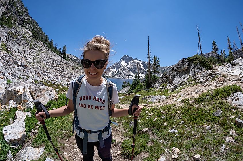 A woman hiker stands on the trail of Sawtooth Lake in Idaho's Sawtooth Mountain Range in the Salmon-Challis National Forest near Stanley, Idaho.