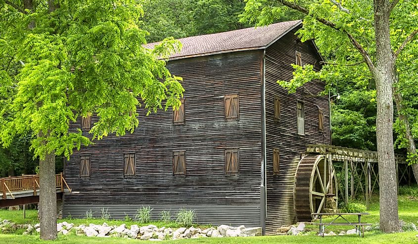 Wolf Creek Grist Mill, Loudonville, Ohio surrounded by green trees