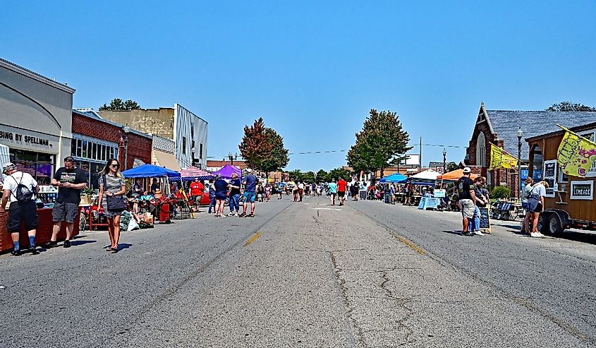 People browse the booths set up along Commercial street in downtown Emporia, Kansas.