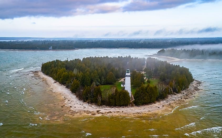 Dramatic aerial image of Cana Island Lighthouse in Wisconsin captured on a foggy day along Lake Michigan shoreline.