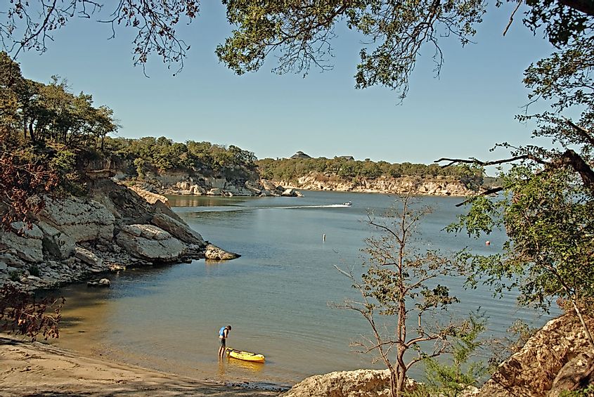 View of Lake Texoma at Eisenhower State Park in Denison, Texas, and a man putting on his life vest to go kayaking
