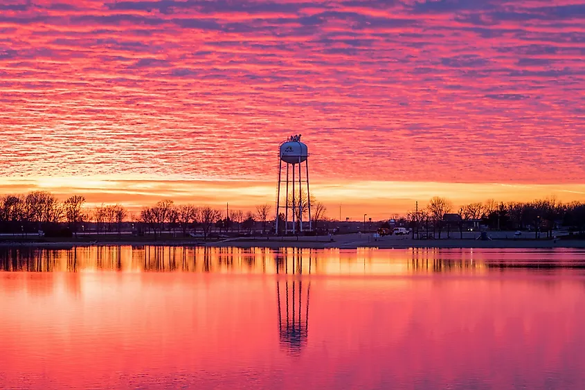 A Dramatic Sunset Sky over the Big Lake Water Tower Reflects in Big Lake.