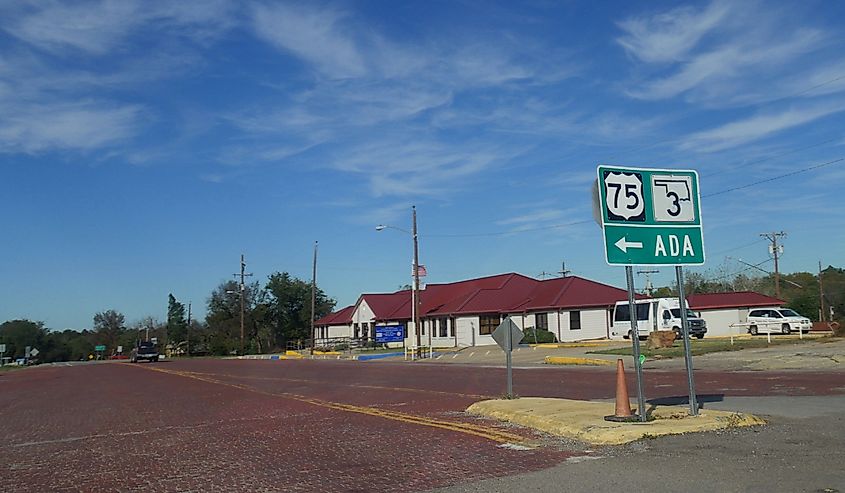 Brick-paved street in an intersection in Ada, Oklahoma, with blue skies on a bright da