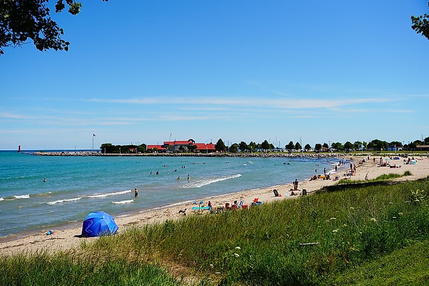 Families come together to play on the sandy beach on shoreline of Lake Michigan in Sheboygan, Wisconsin.