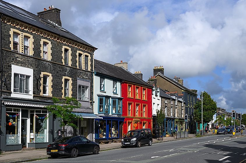 Machynlleth, Wales, UK - Cityscape view along Heol Maengwyn in Machynlleth in central Wales of businesses.