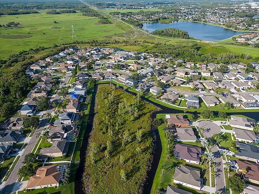 An aerial view of a neighborhood of New Port Richey, Florida surrounded by greenery