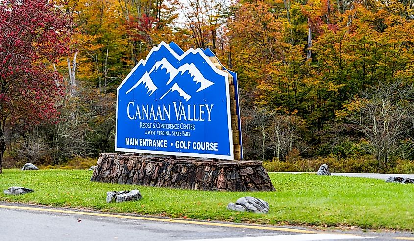 Sign on road for canaan valley ski resort area and conference center in West Virginia during colorful autumn fall season with foliage on trees