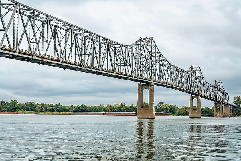 The cantilever Cairo Ohio River Bridge stretching across the river, surrounded by beautiful fall scenery. The steel structure provides a vital crossing between Wickliffe, Kentucky, and Cairo, Illinois. 
