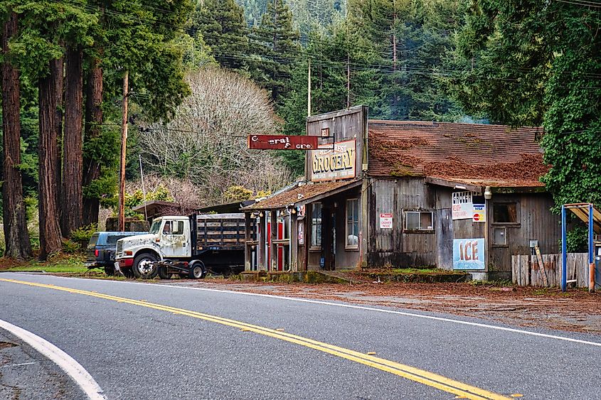 Garberville, California: two pick up trucks are parked next to a grocery or general store along the avenue of the giants