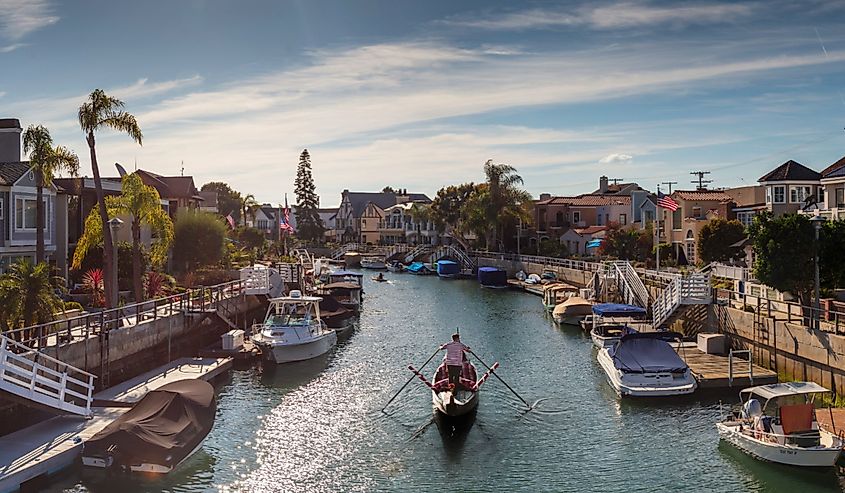 People boating and having fun on a summer day in the canals of Naples Island in Long Beach California