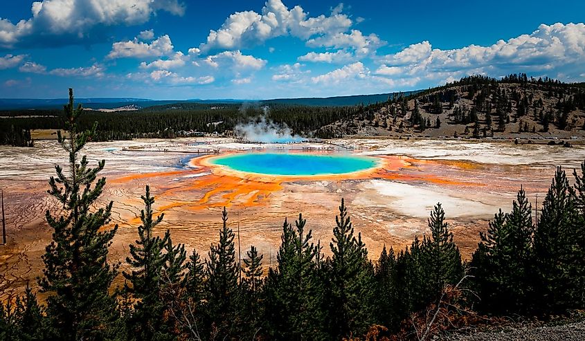 Colorful Grand Prismatic Spring view at Yellowstone National Park with mountains in the background