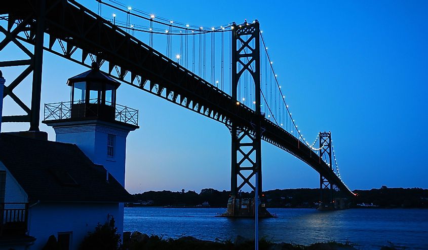 A lighthouse stands at the base of the Bristol Mount Hope Bridge in Rhode Island