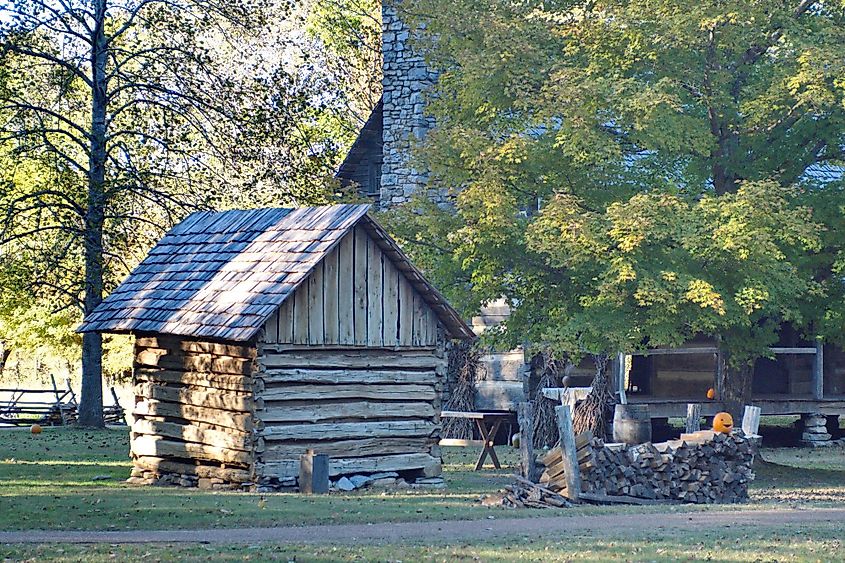 Jack-o-lantern on a wood pile in a historical farm reenactment at the Land between the lakes state recreational area near Paducah, Kentucky