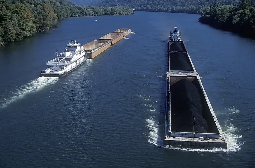 A towboat pushing loaded coal barges along a river in West Virginia