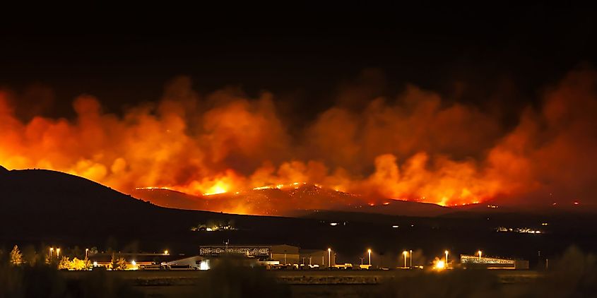 Wildfire burning at night in Northern Nevada with smoke and flames