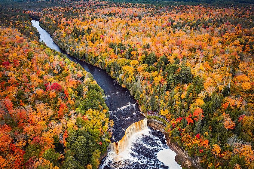 Incredible aerial photograph of the upper waterfall cascade at Tahquamenon Falls with beautiful autumn foliage
