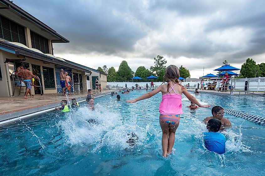 Visitors enjoy swimming at a community recreation center swimming pool in Mililani, Hawaii