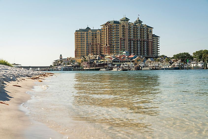 Destin, Florida beach with hotels and calm ocean waters.