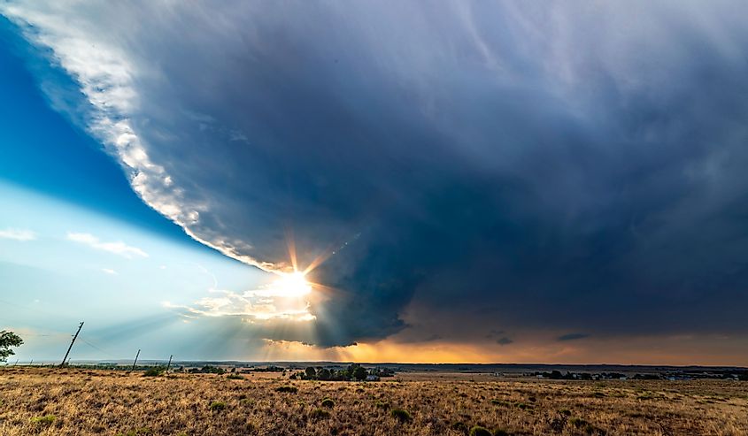 Large, powerful tornadic supercell storm moving over the Great Plains during sunset, setting the stage for the formation of tornados across Tornado Alley.