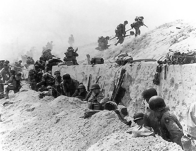 U.S. soldiers of the 8th Infantry, 4th Infantry Division advance over the sea-wall at Utah.