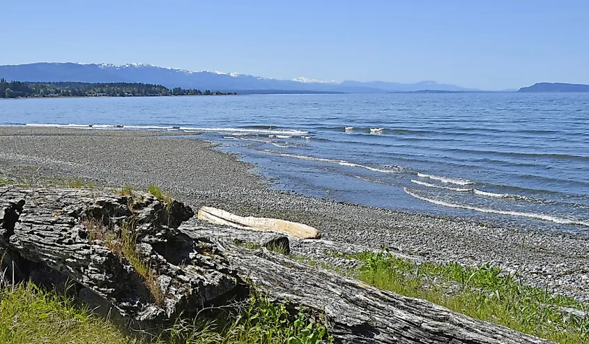 view over the Georgia Strait from Qualicum Beach on a suny day with blue sky, Vancouver Island British Columbia Canada.