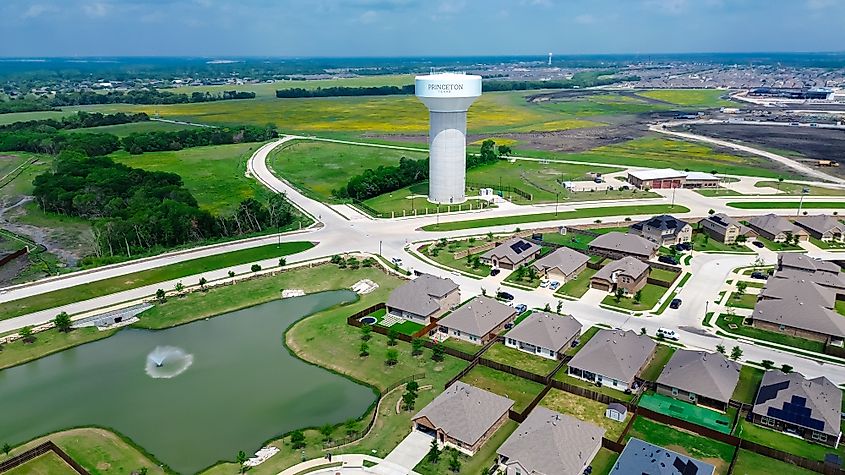 Lakeside two story houses with fountain, water tower along Myrick Lane in Princeton, Texas