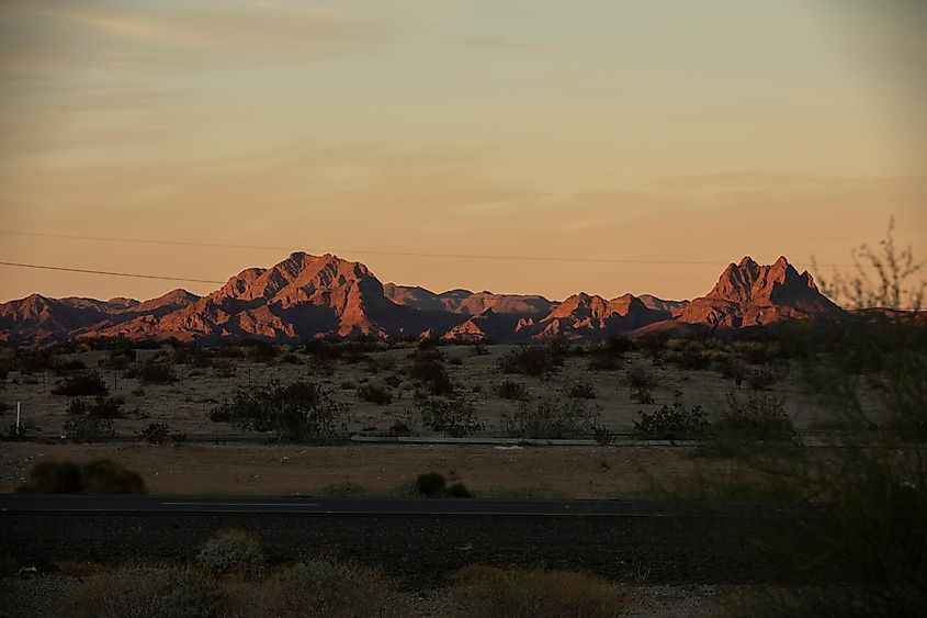 Sunset light shines on the desert landscape and mountains of Wellton, Arizona, USA.