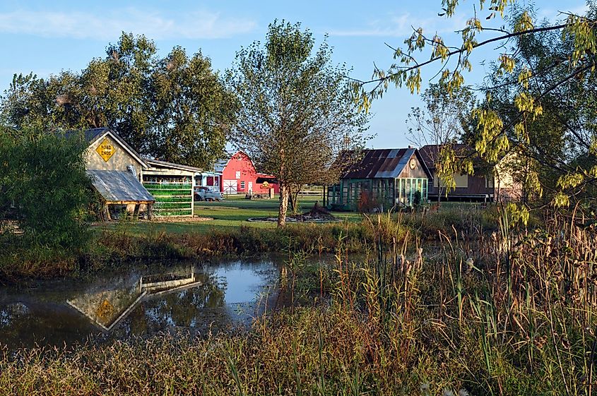 Buildings reflected in a pond at Red Oak II, north of Carthage, Missouri